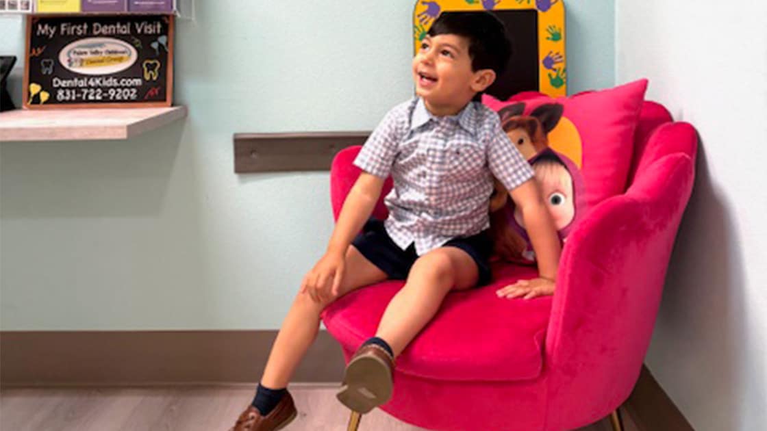 Little boy in chair smiling